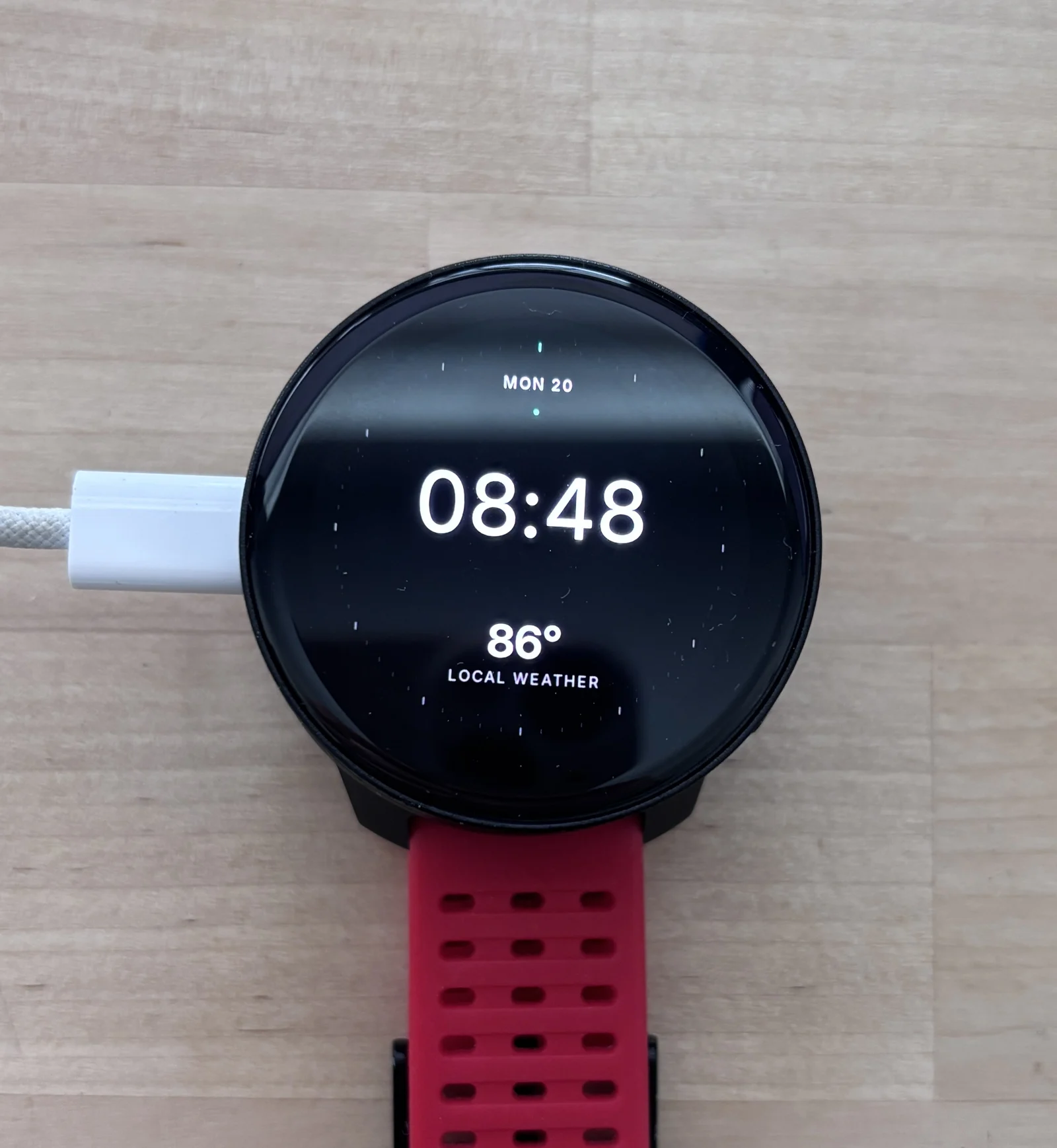 The round Circa wearable prototype on a workbench.